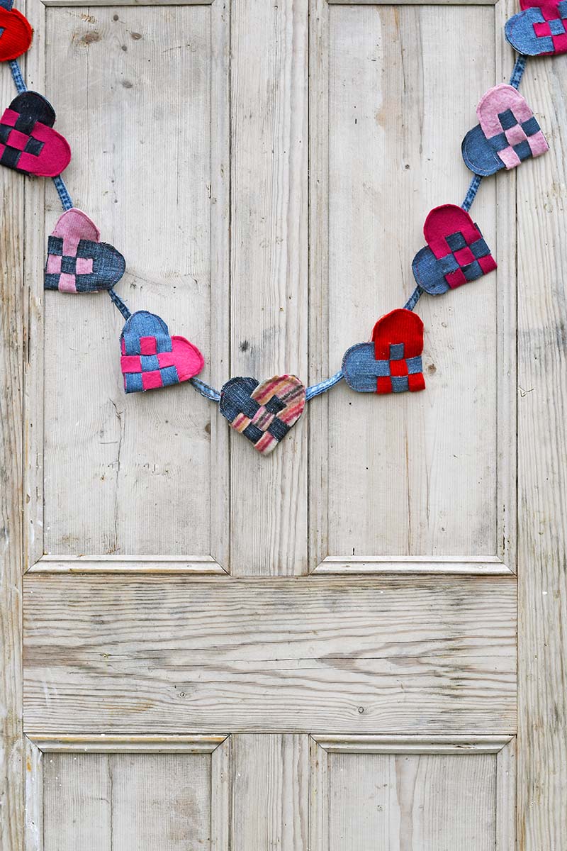 Upcycled denim and felt woven Scandinavian hearts on door.