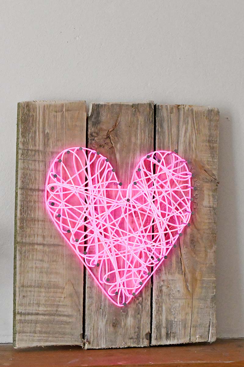 Neon heart sign made with el wire string art