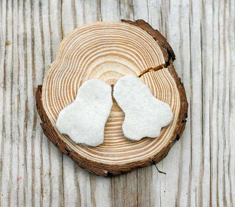 Sticking bunny feet to the wood slice base.