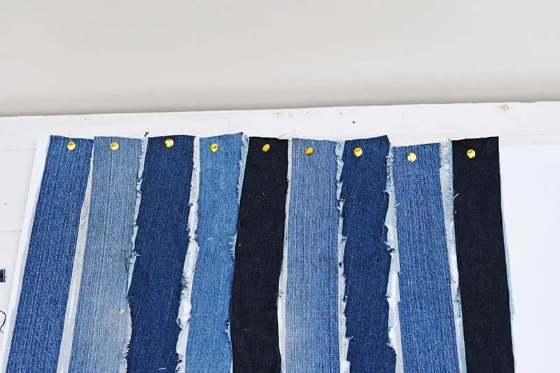 pinning denim strips to the foam board