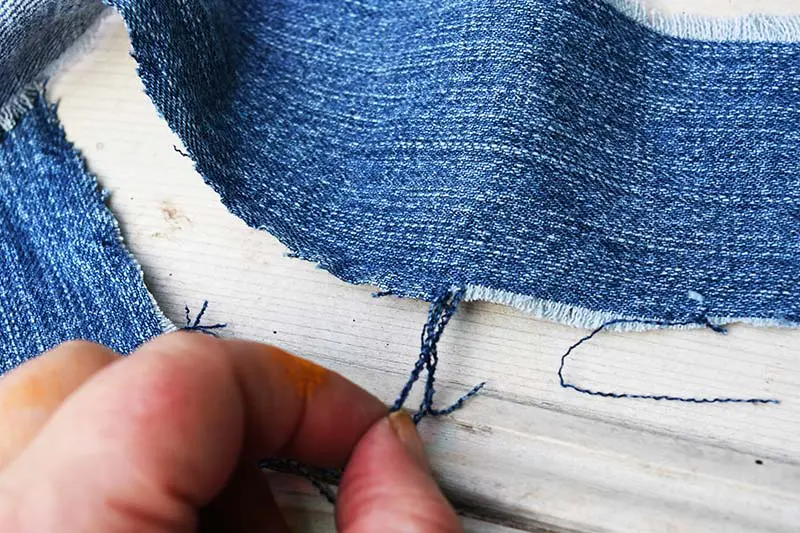 fraying denim by pulling threads