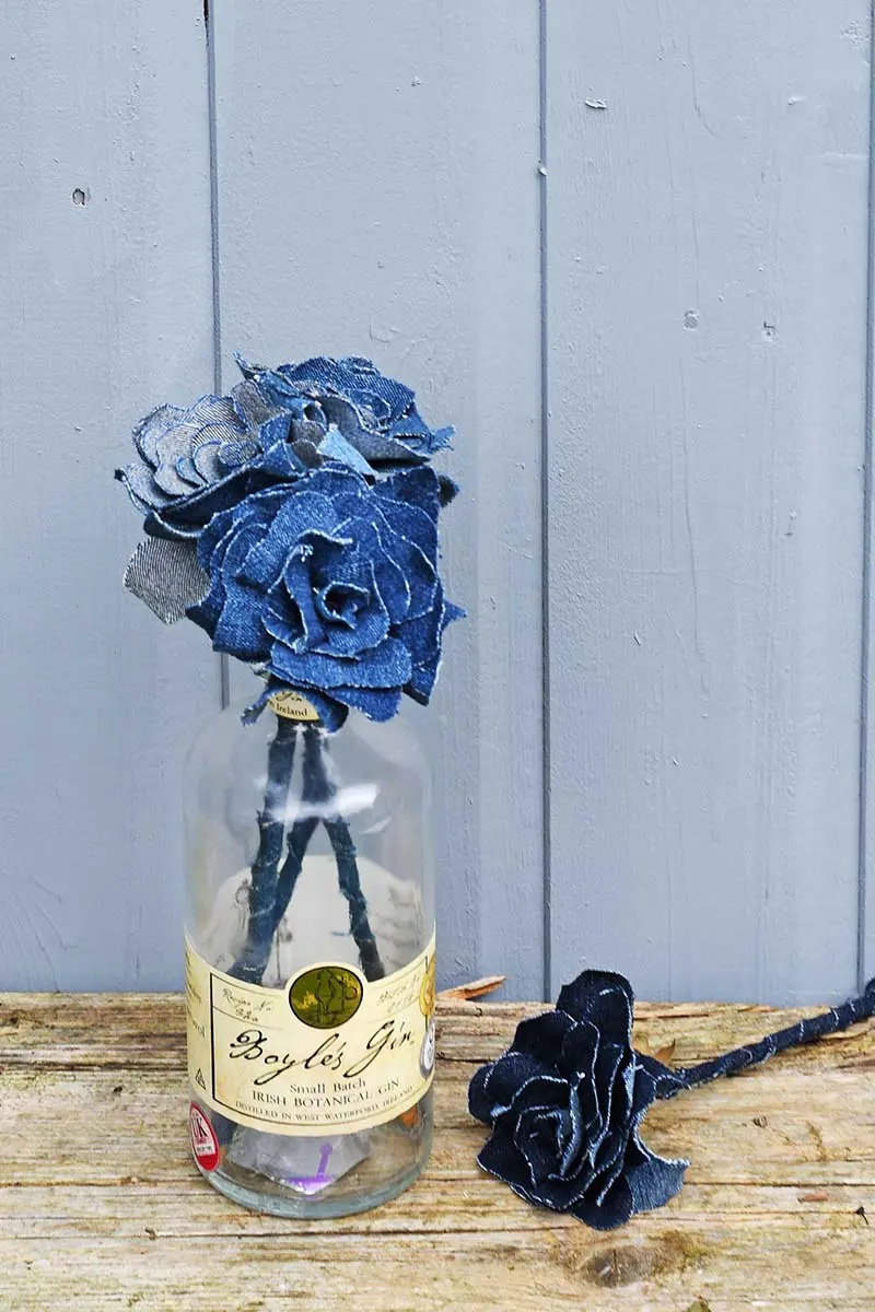 Denim flowers in gin bottle