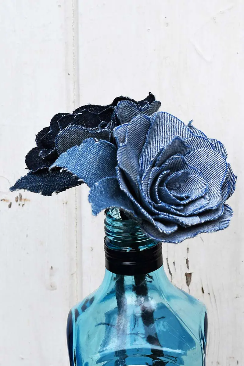 Denim roses in Bombay saphire bottle