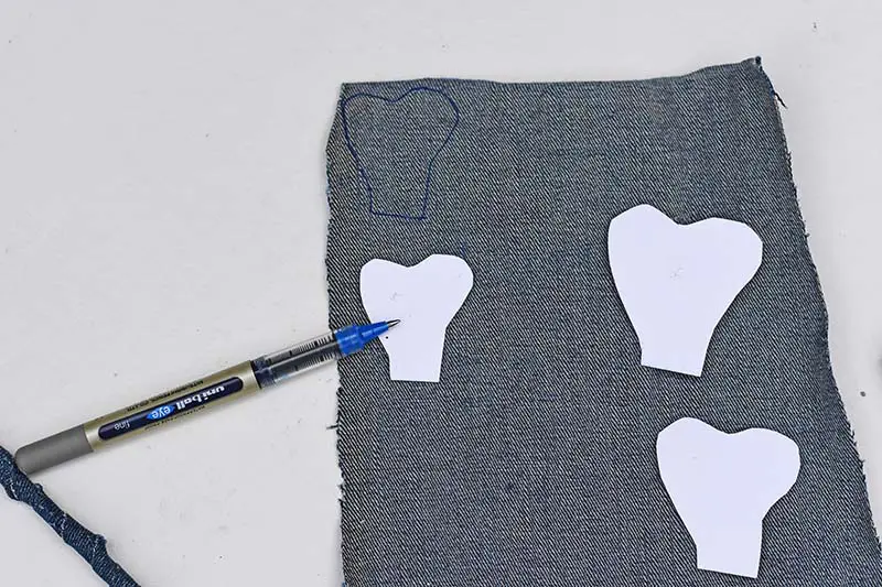 Drawing around and cutting out denim petals
