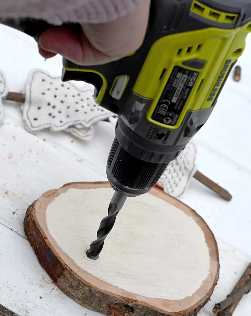 Drilling hole in wood slice
