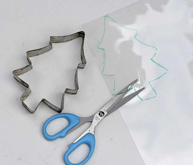 cutting the shape out of shrink plastic.