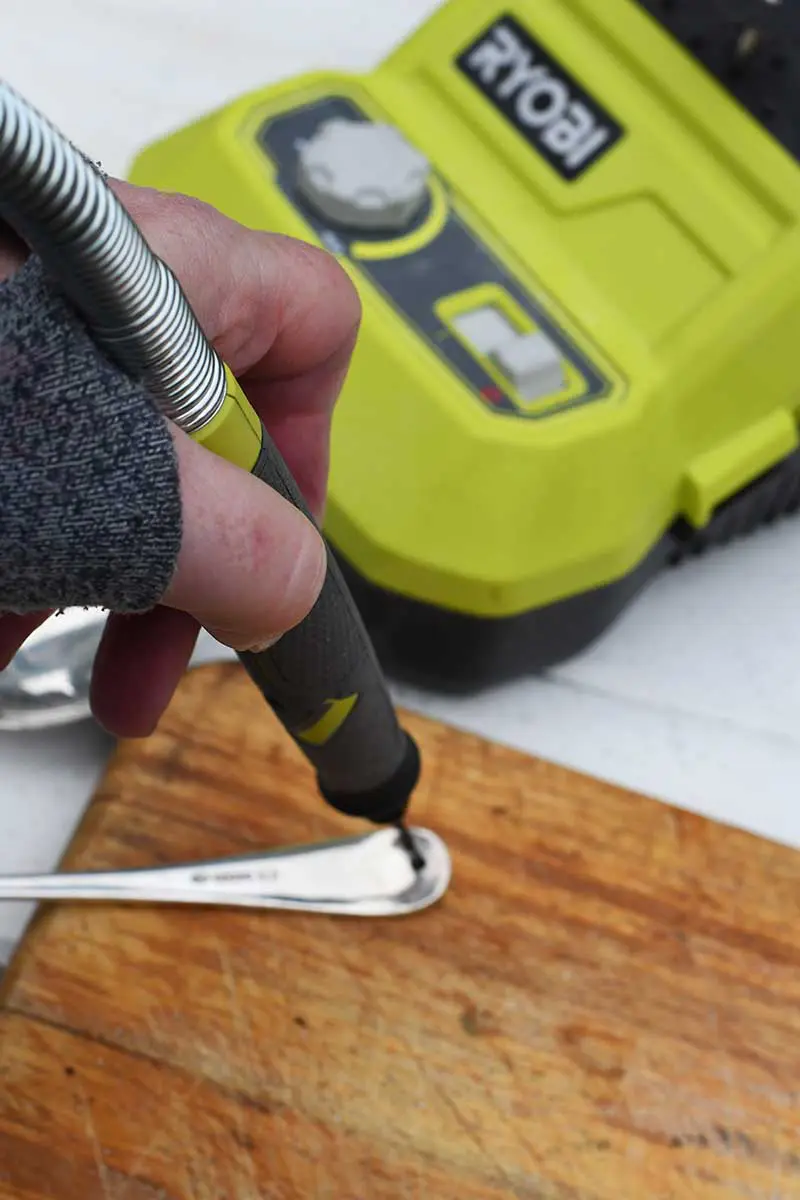 drilling hole into spoon.