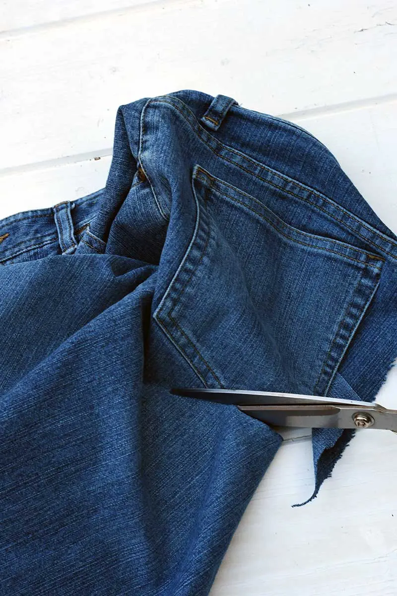 cutting out a back pocket with scissors.