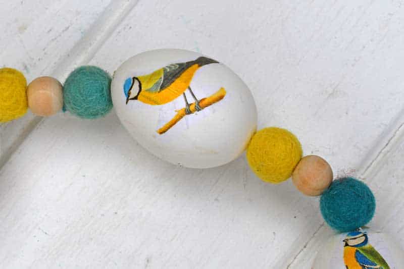 Threading felt balls and beads and eggs