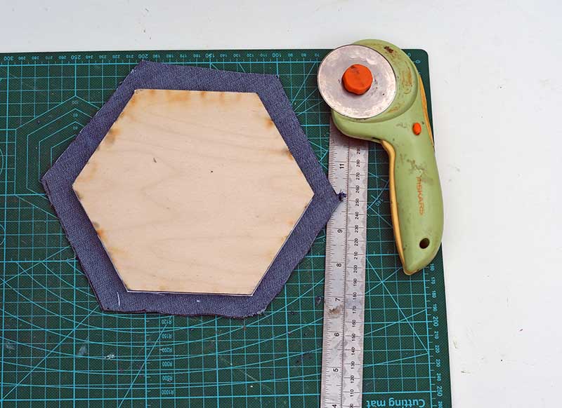 cutting out denim hexagons