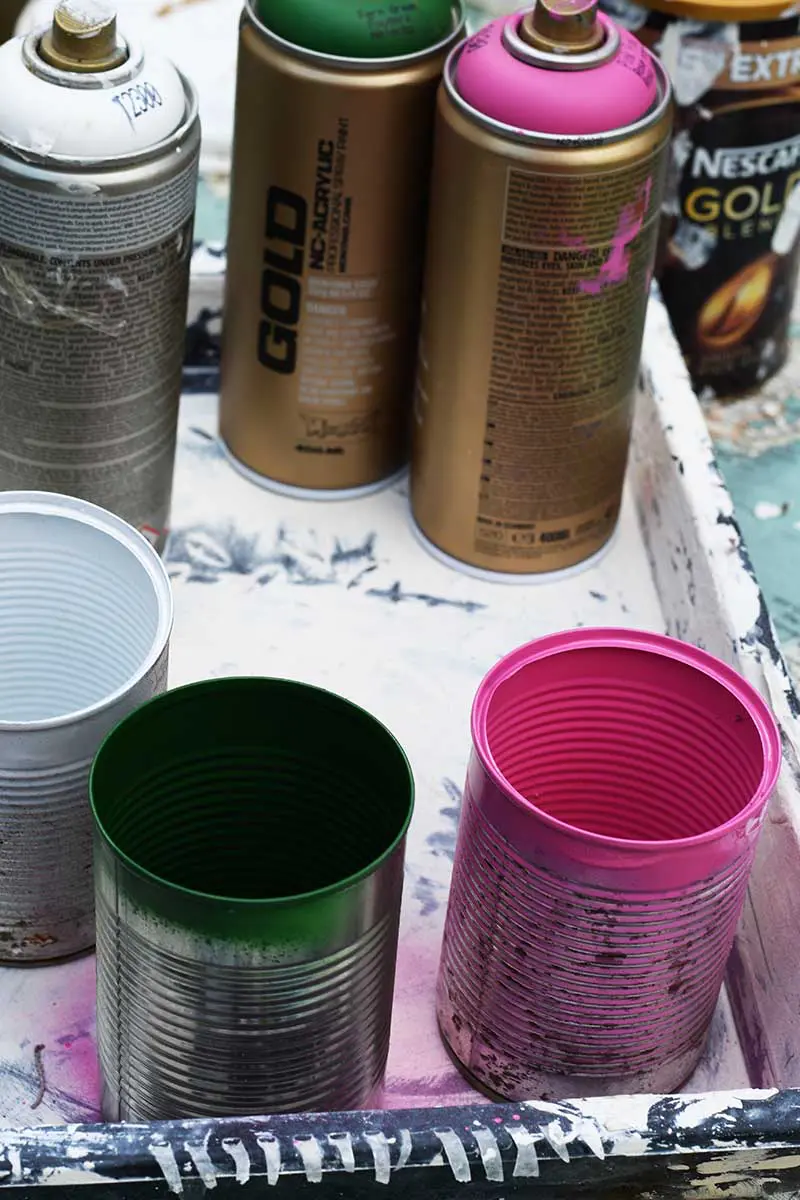 spray painting the tin cans