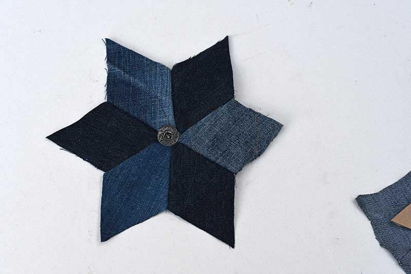 adding a button to upcycled denim quilted stars.