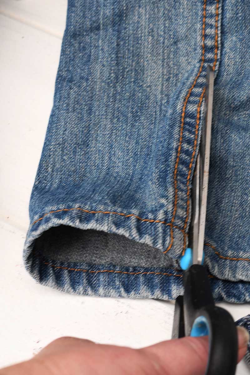 Cutting the seams out of old jeans