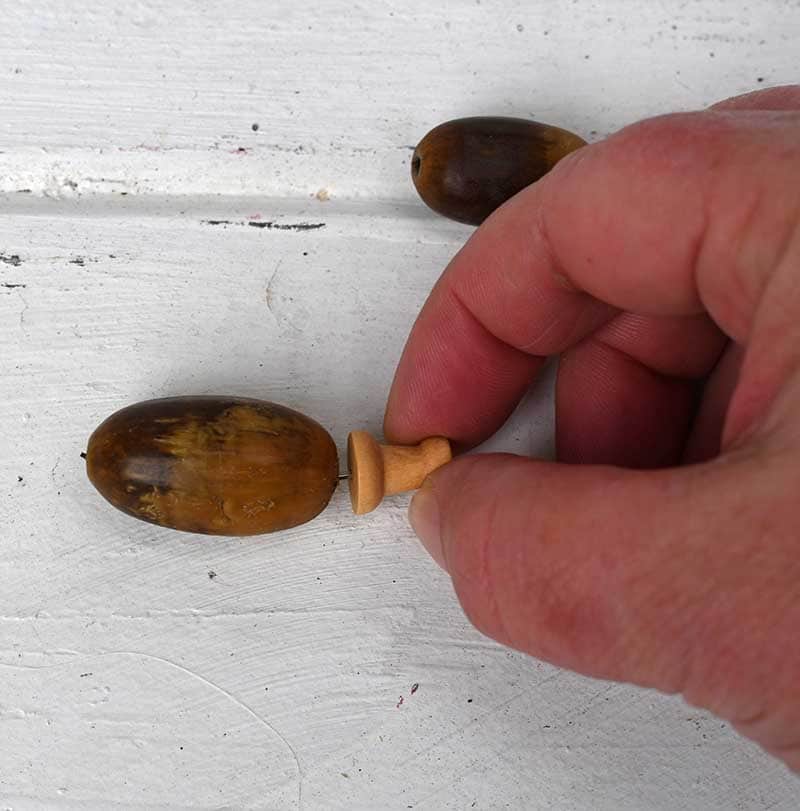 putting in drawing pin in nut