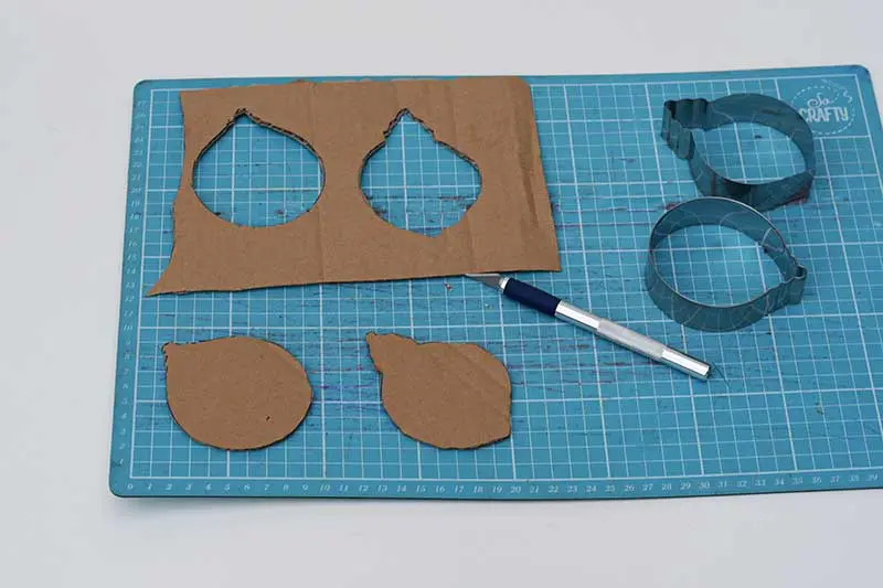 cutting out the cardboard shapes