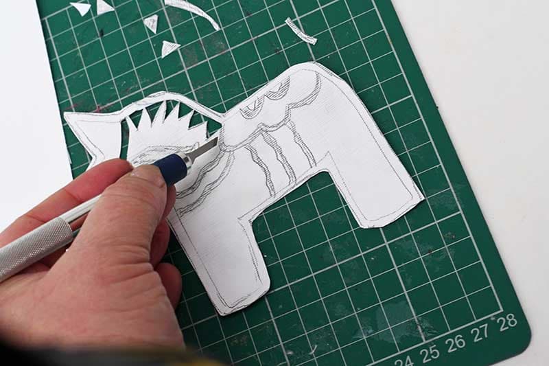 Cutting out Dala Horse stencil