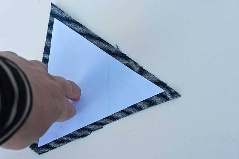 sticking paper triangle to denim