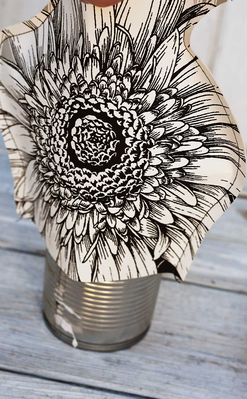 placing paper vase over a tin can