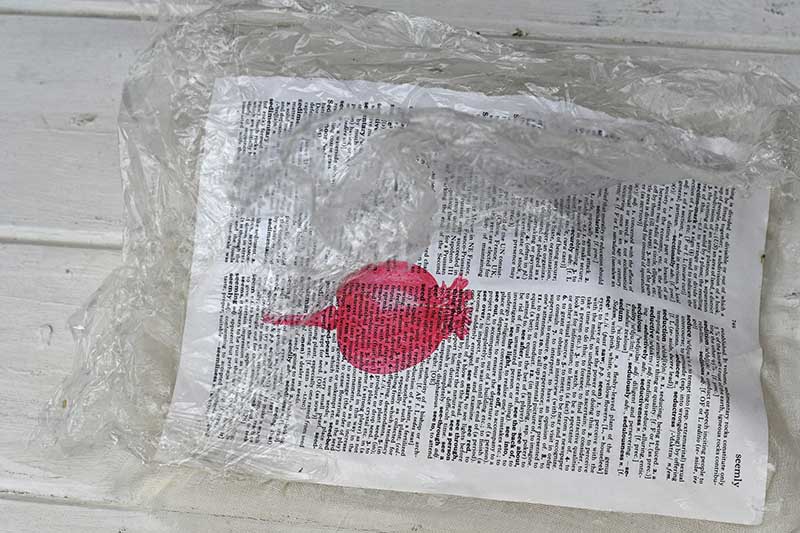 removing the cling film from the paper