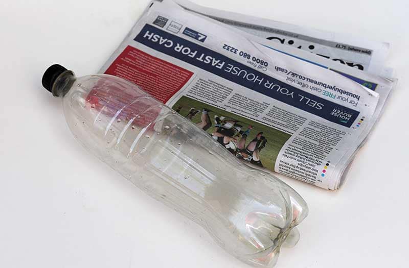 coke bottle and newspaper 