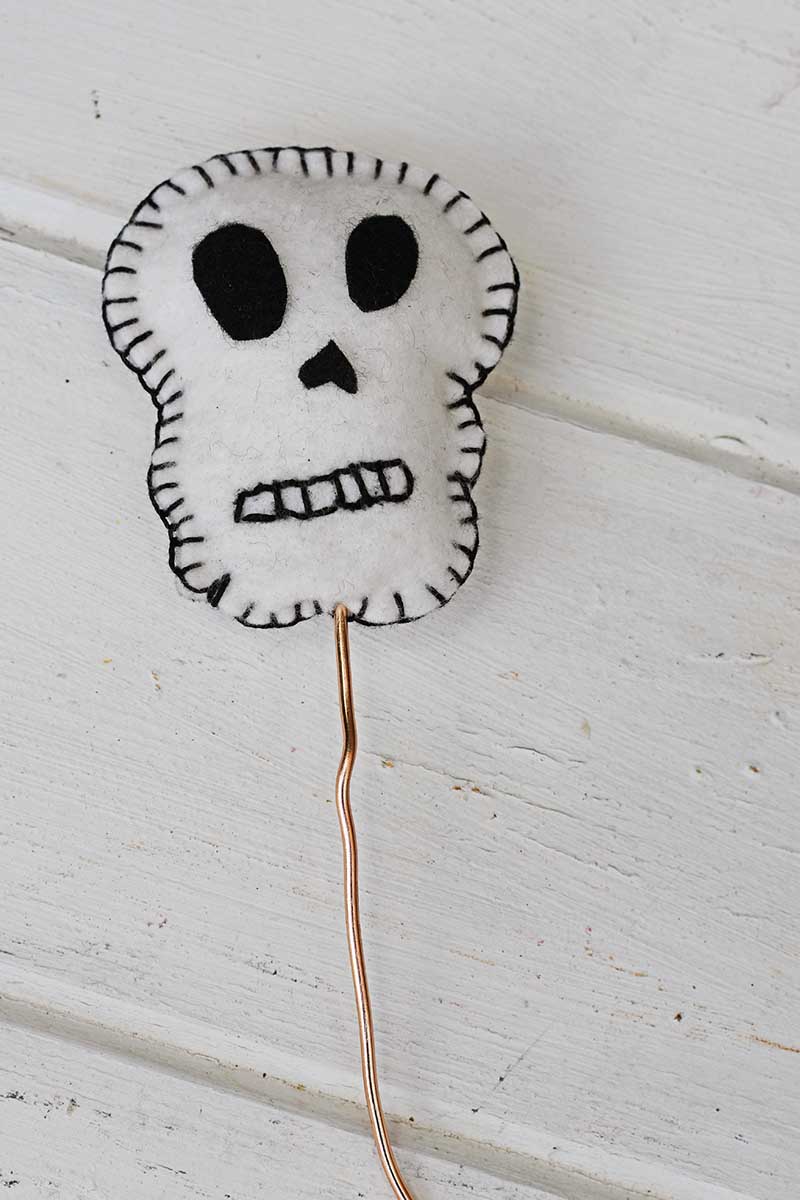 Attaching wire to embroidered skulls