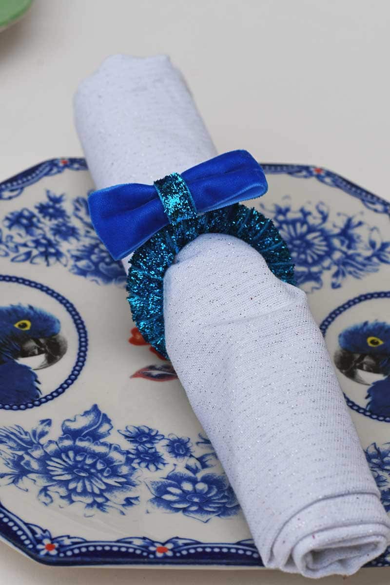 blue velvet napkin ring on blue plate