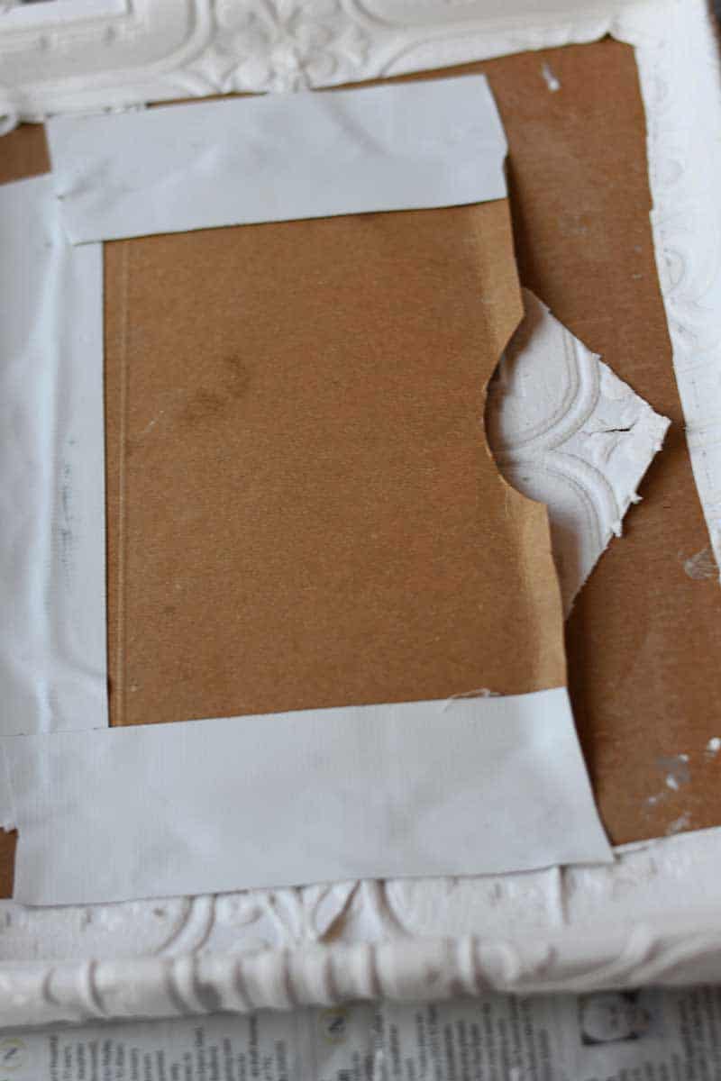 Taping envelope to the back of the upcycled photo frame