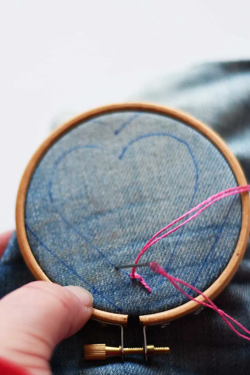 embroidering a denim heart
