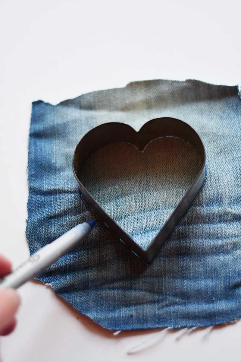 Drawing a heart on scrap denim