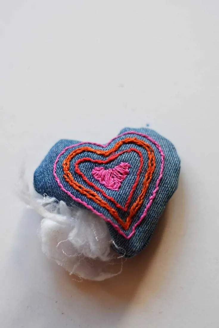 Stuffing denim embroidered heart.