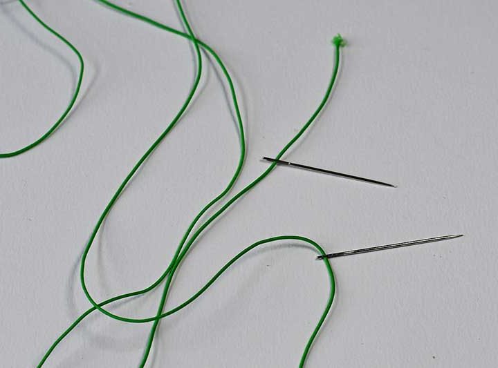 Threaded elastic string to make a paper bead bracelet