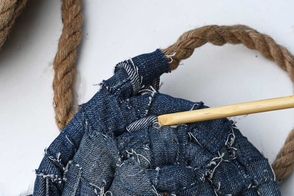 making a rag rug by coiling and wrapping fabric yarn.