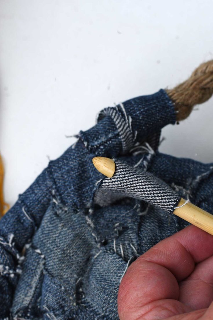 pulling the denim yarn through