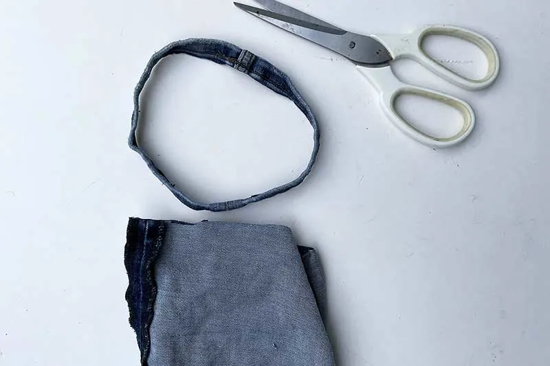 Cutting the hem off the base of a jeans leg