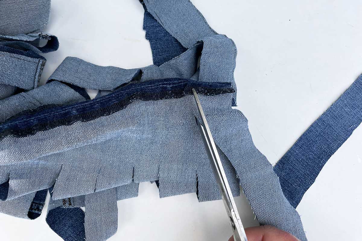 Cutting the yarn from jeans legs