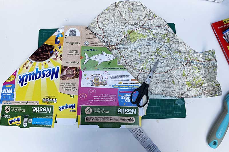 Covering cereal box cut out with maps
