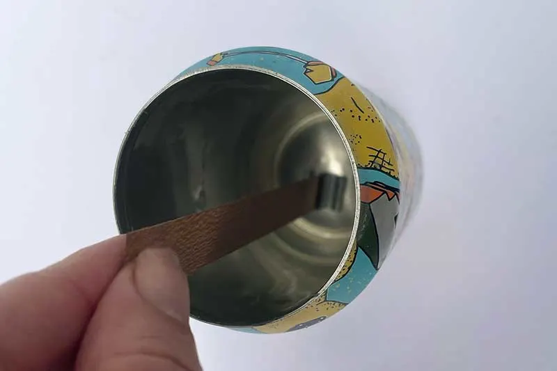 Putting wooden wick into beer can