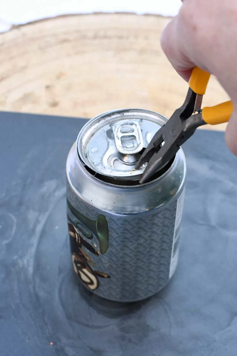 This beverage opener removes the lid from beer and soda cans