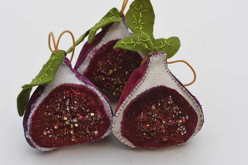 three fabric fig ornaments