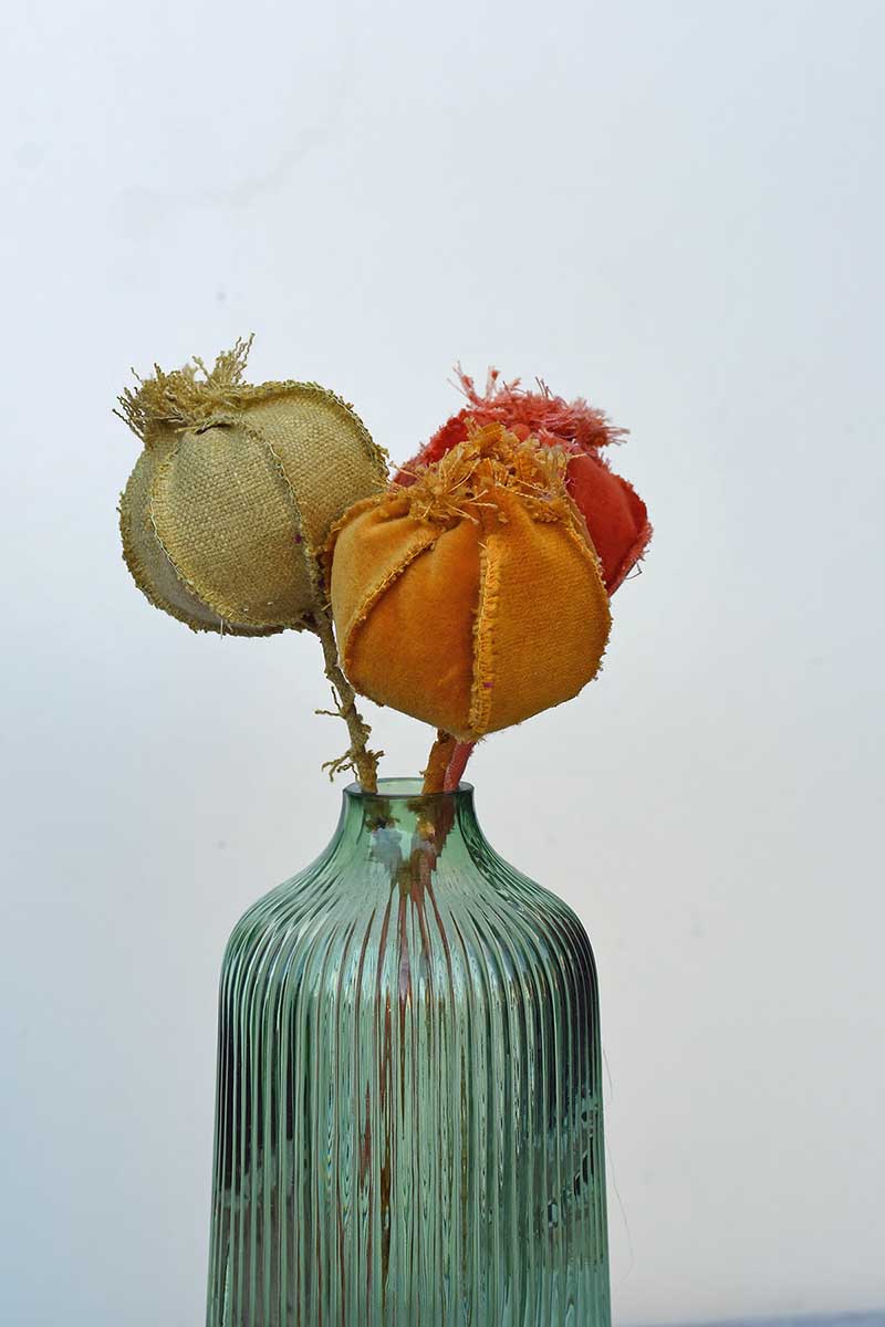 Velvet fabric poppy heads in vase