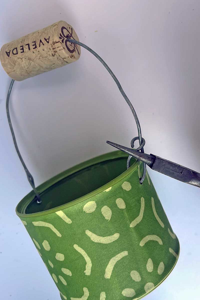 Adding wire handle to upcycled tin can Easter baskets
