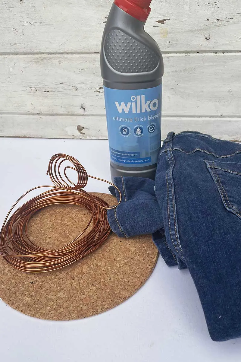 Bleach, cork trivet, wire and jeans for a fake snake plant