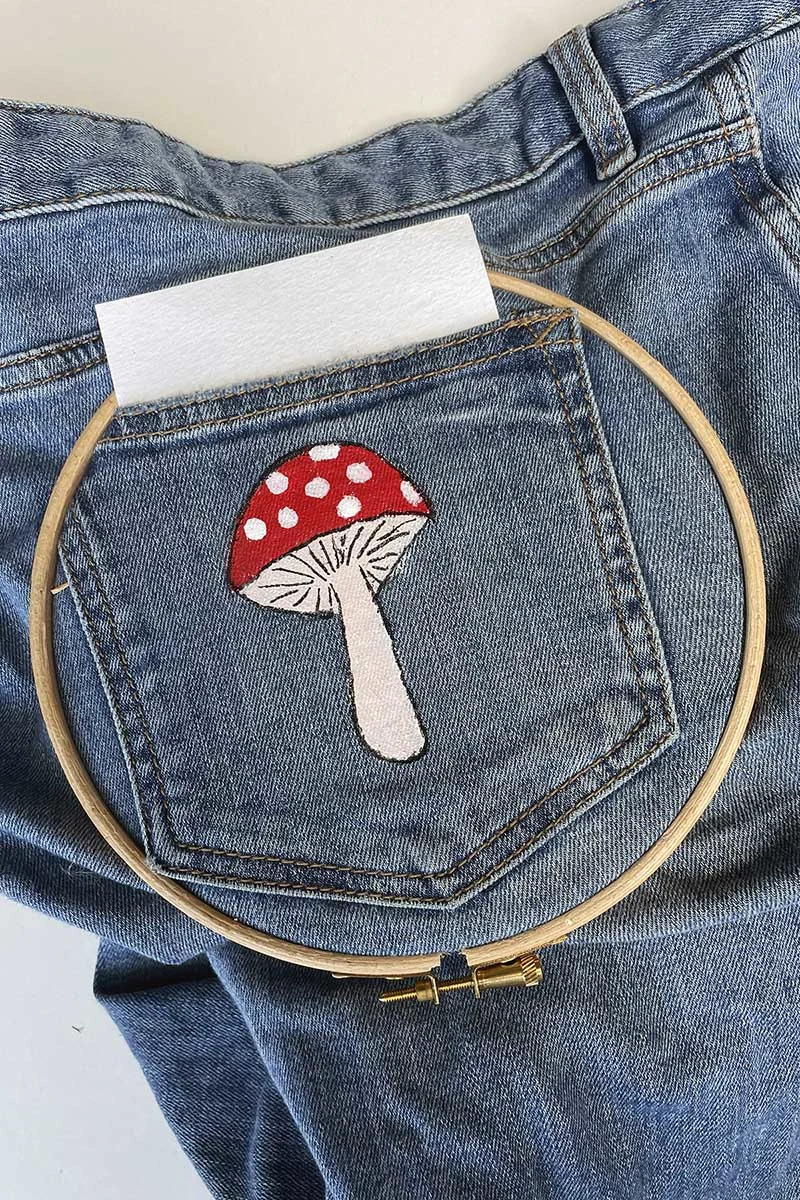 Painting on a mushroom on a jeans pocket