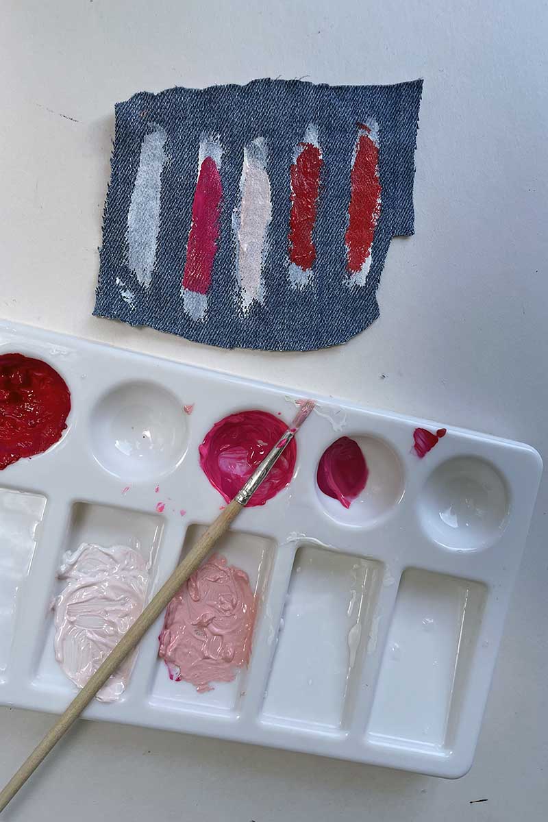 testing paint colours on a swatch when painting on jeans.