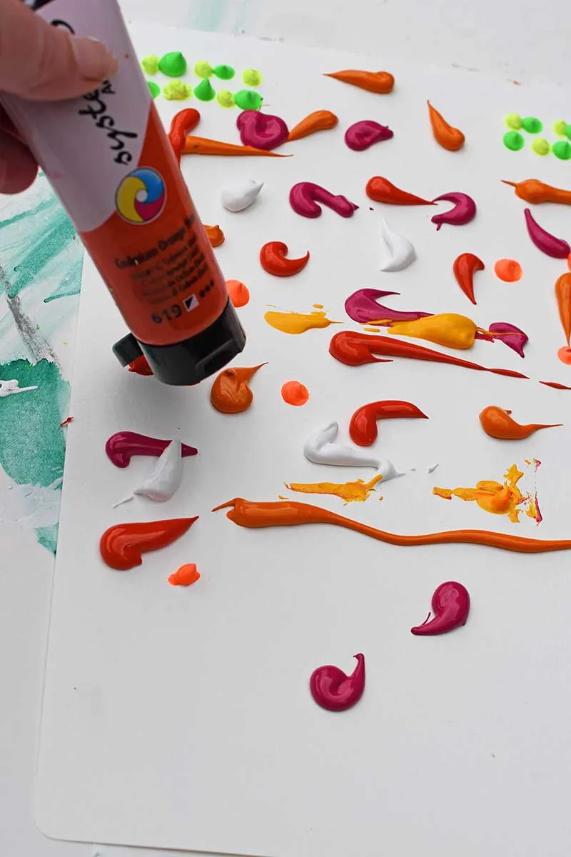 Putting paint blobs onto to paper for squeegee abstract painting