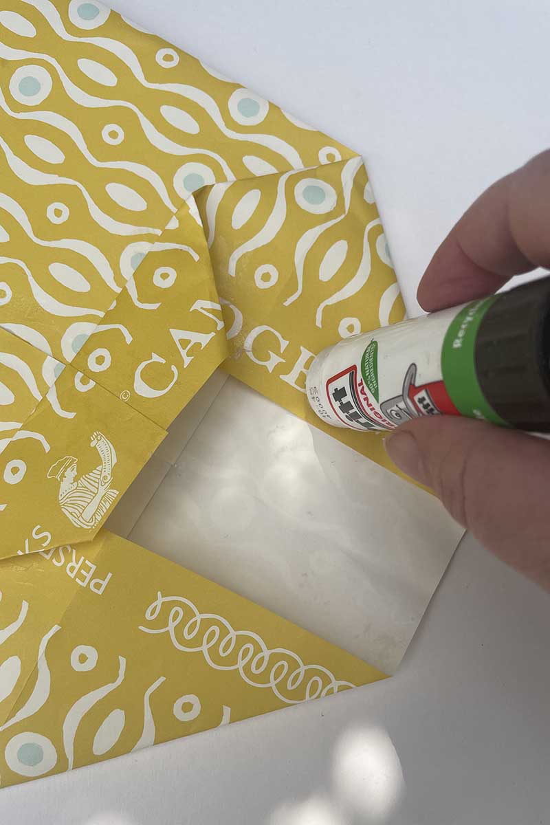 gluing the base of the wrapping paper gift bag