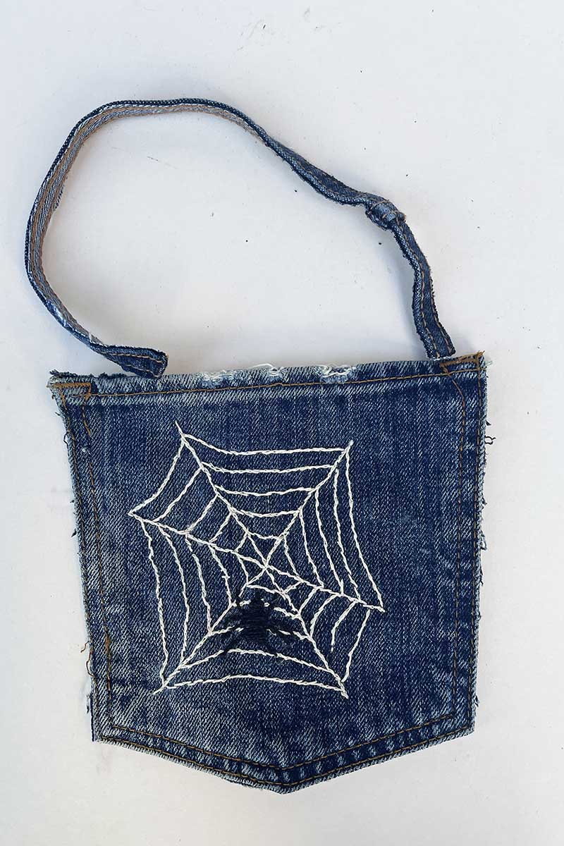 Adding a denim seam hanging loop to jeans embroidered Halloween pockets