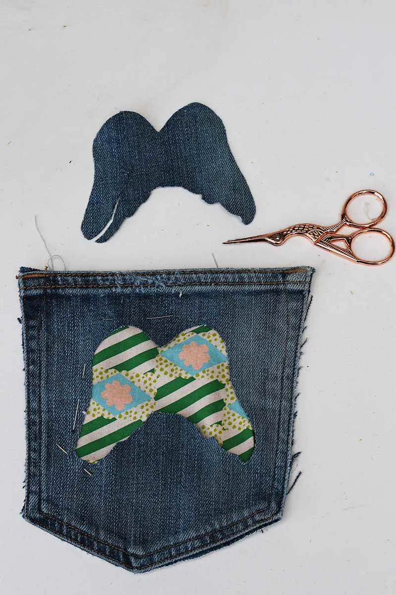 Cut out pocket shape and scrap fabric backing