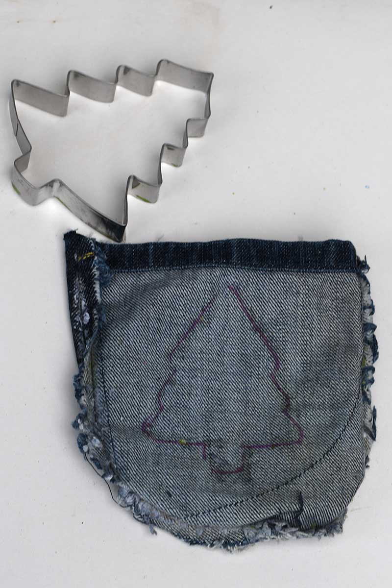 Drawing around cookie cutter on denim pocket