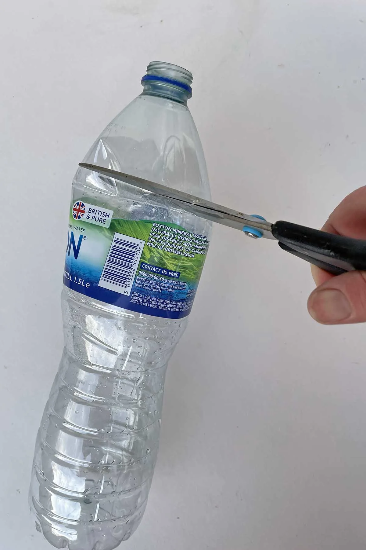cutting the top off the plastic water bottle